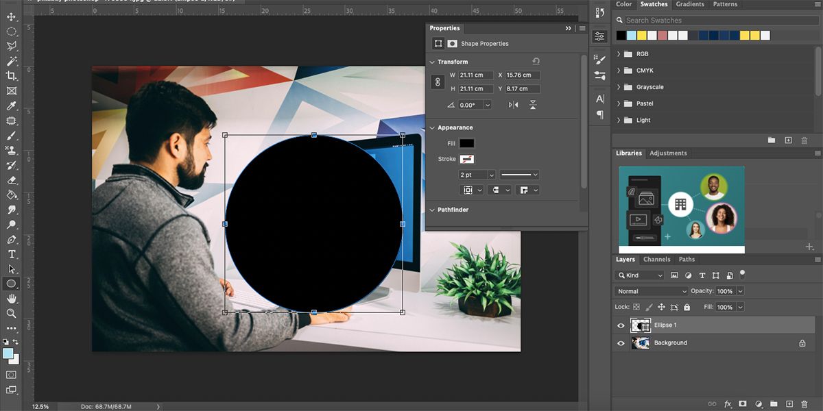 Photoshop screen with image of man at Mac and large black ellipse over the top.