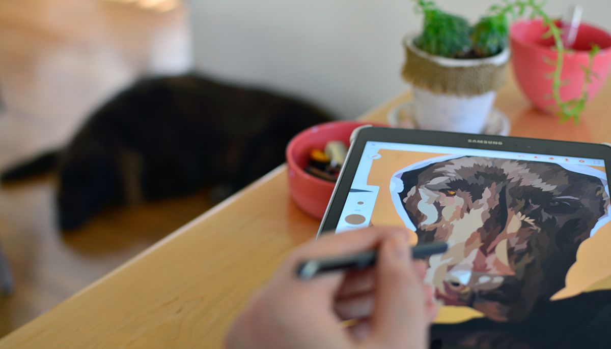 Digital drawing of a dog on a tablet in focus, with blurred dog lying on the floor in the background.