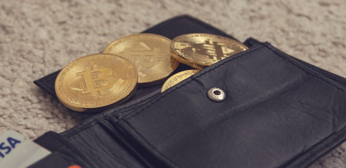gold bitcoins in black wallet