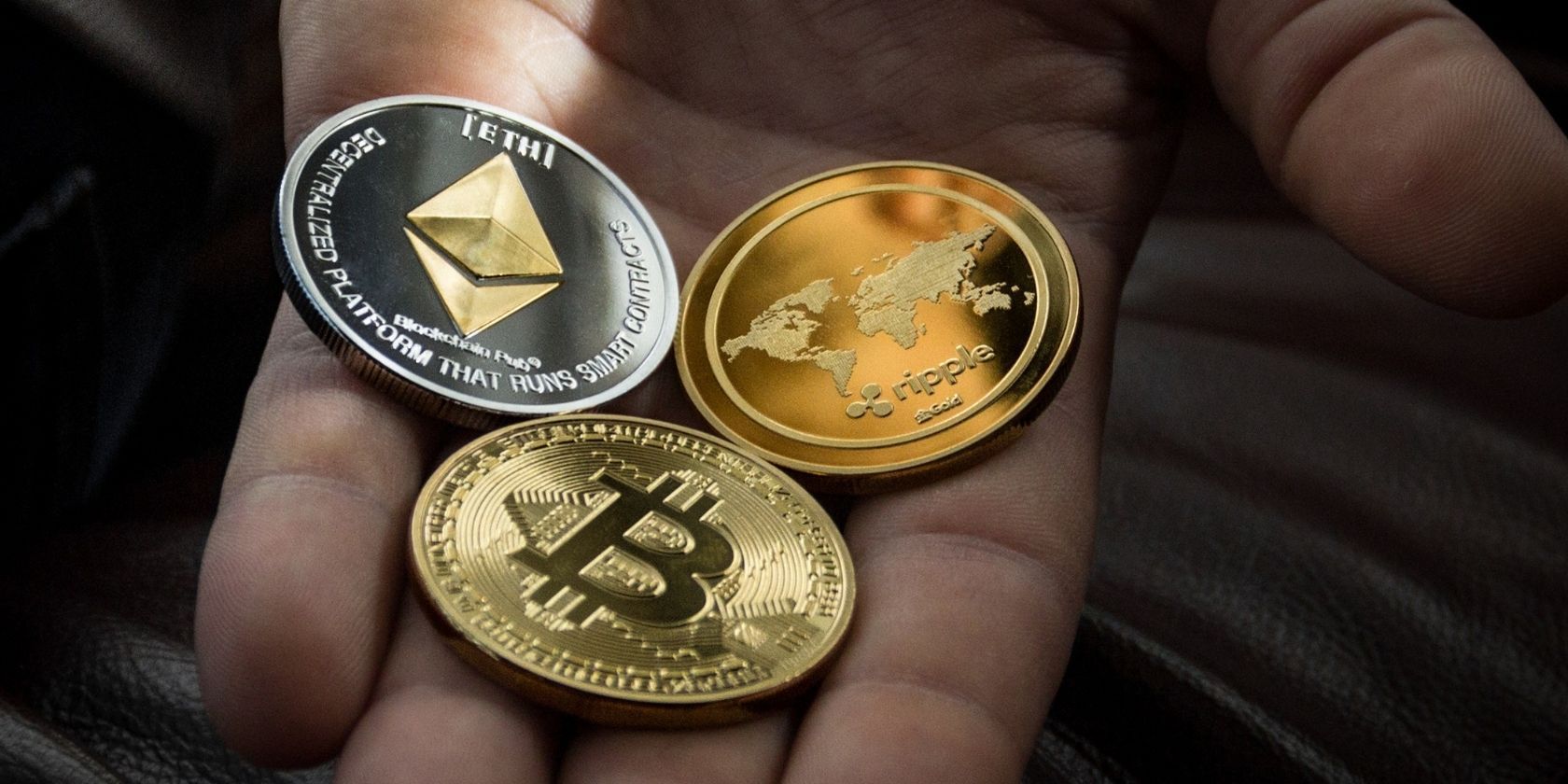 various crypto coins in hand
