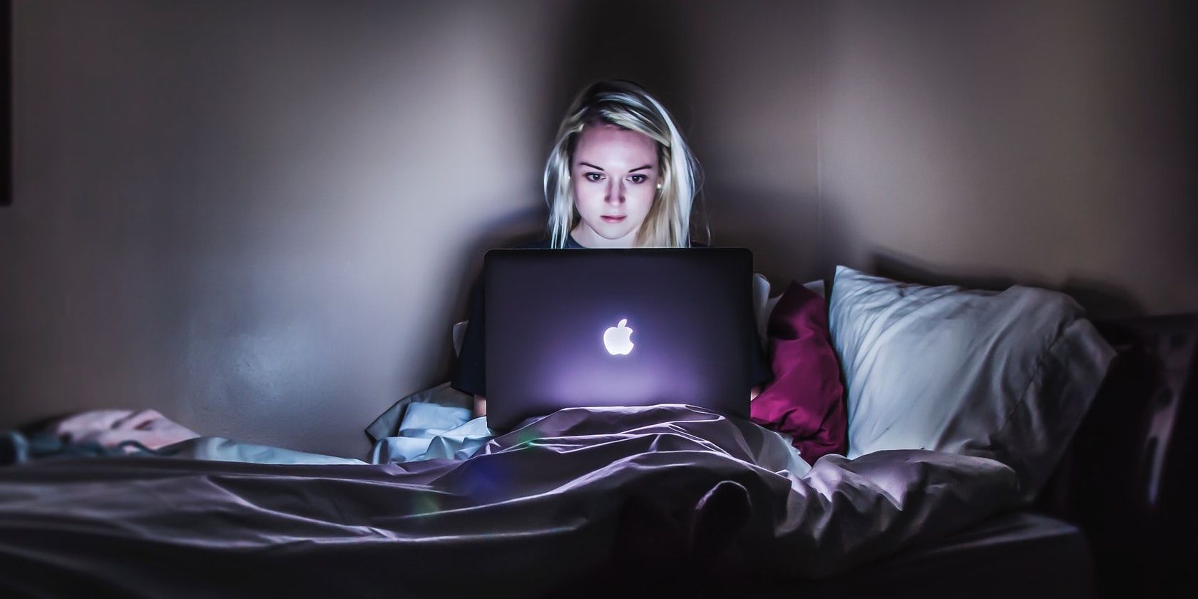 Girl Working on Computer in Bed