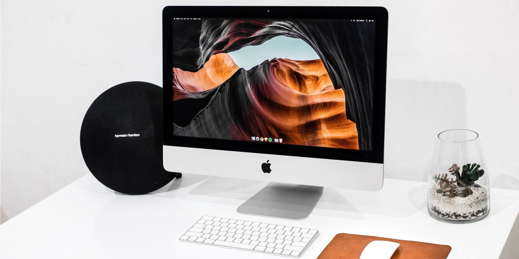 iMac on desk with big round speaker