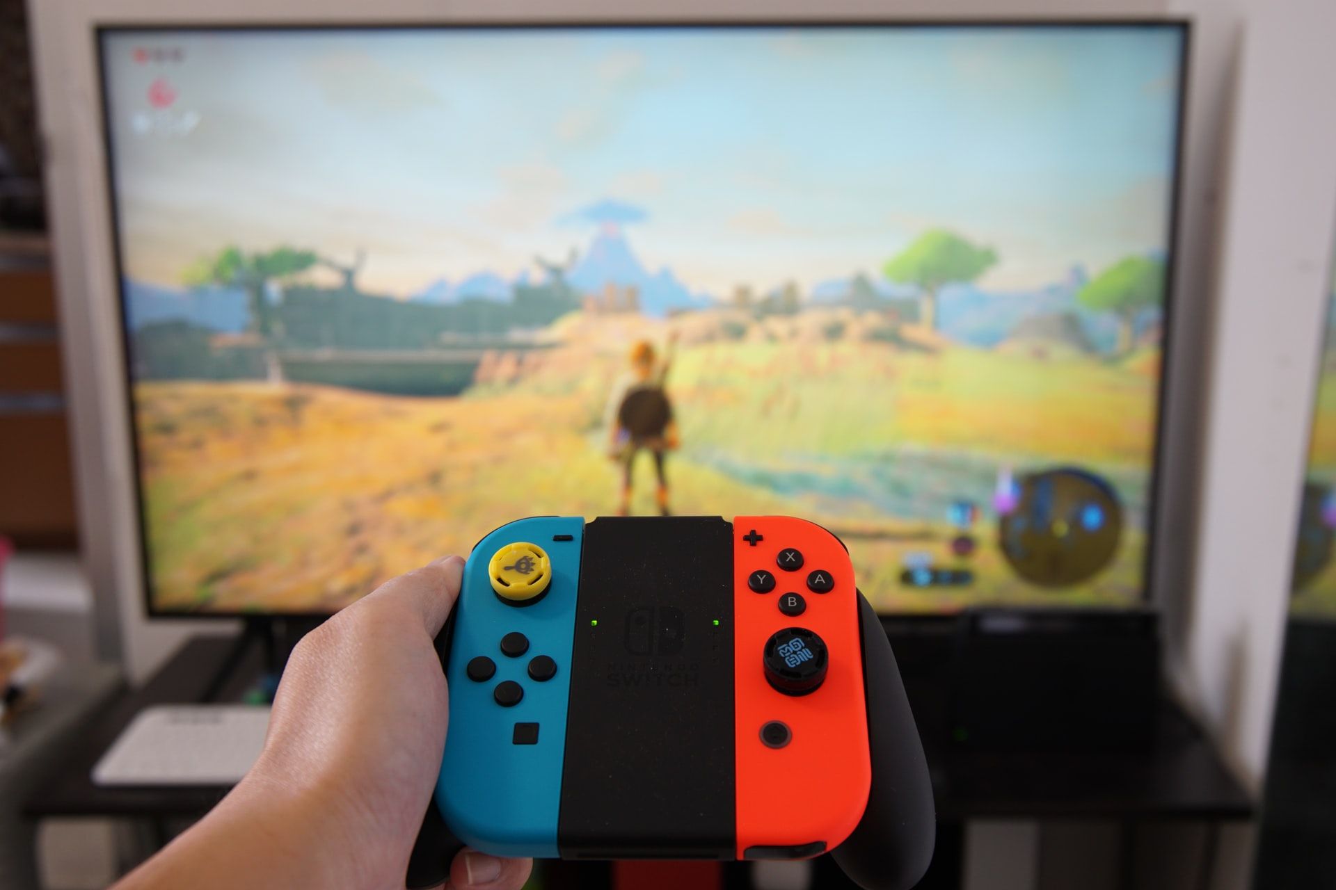 Image of a joycon with BOTW running in the background