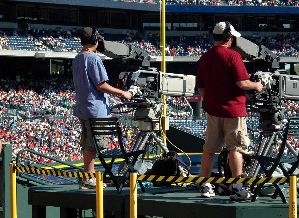 cameramen recording a live tv sports event in stadium