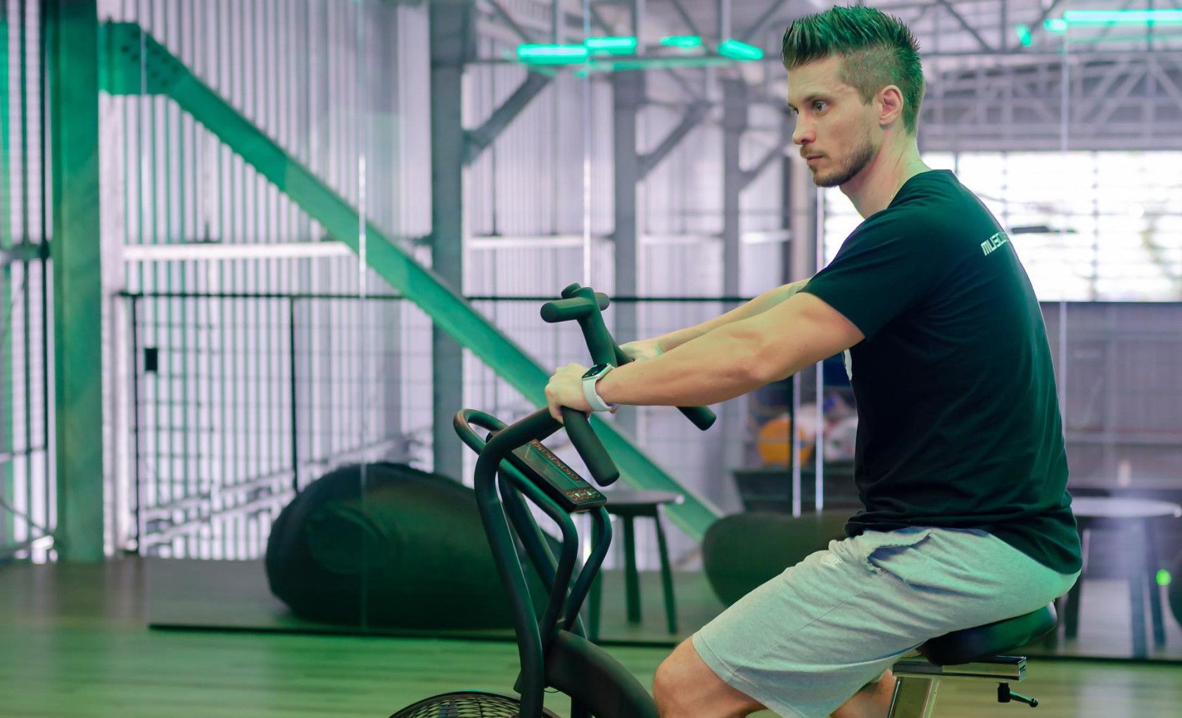 Man sitting on indoor stationary exercise bicycle