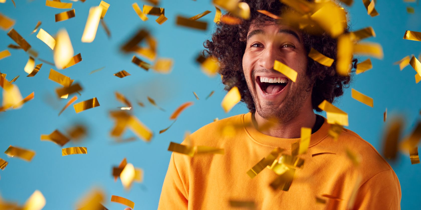 man smiling with confetti falling