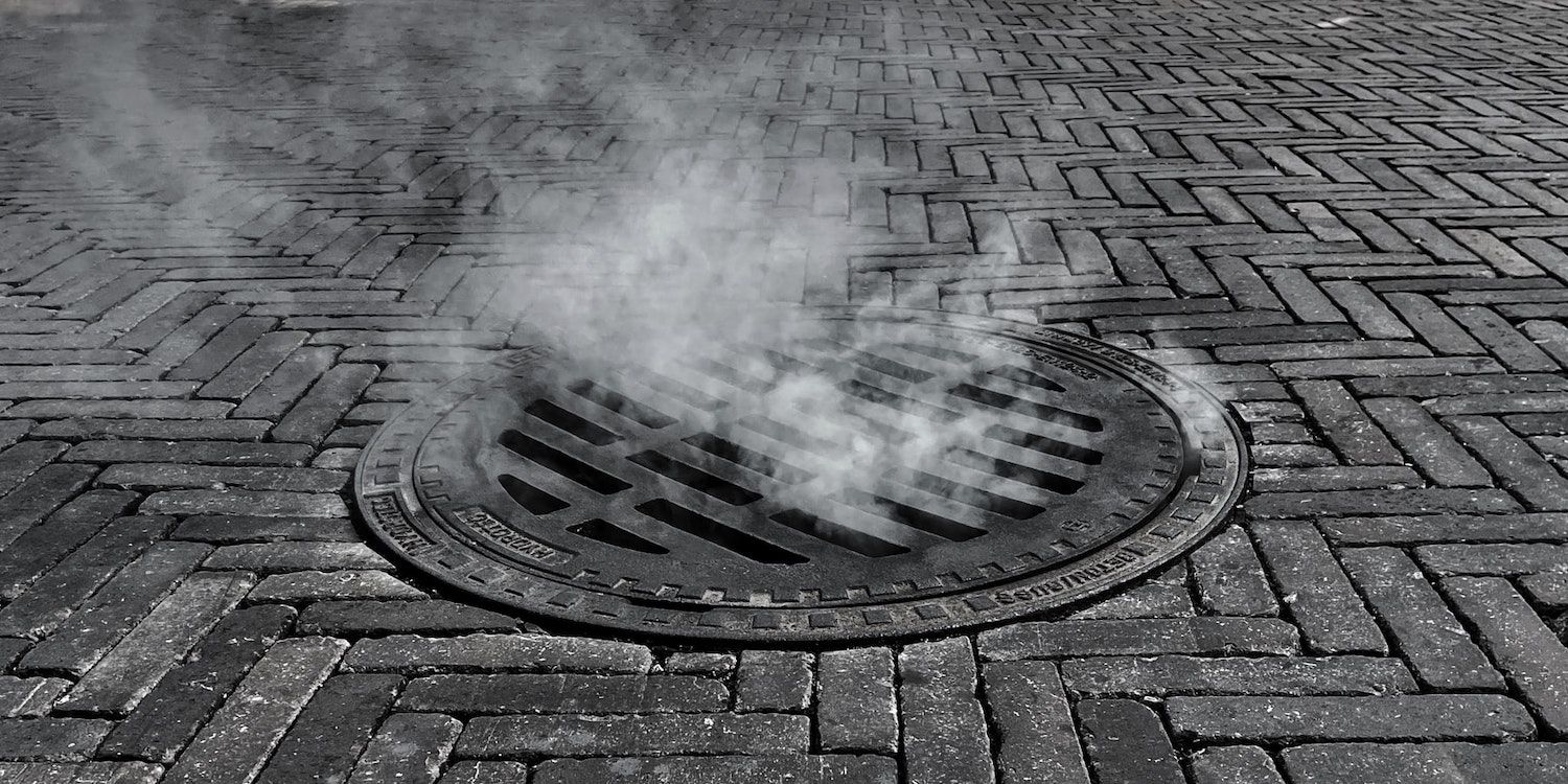 manhole and steam black and white