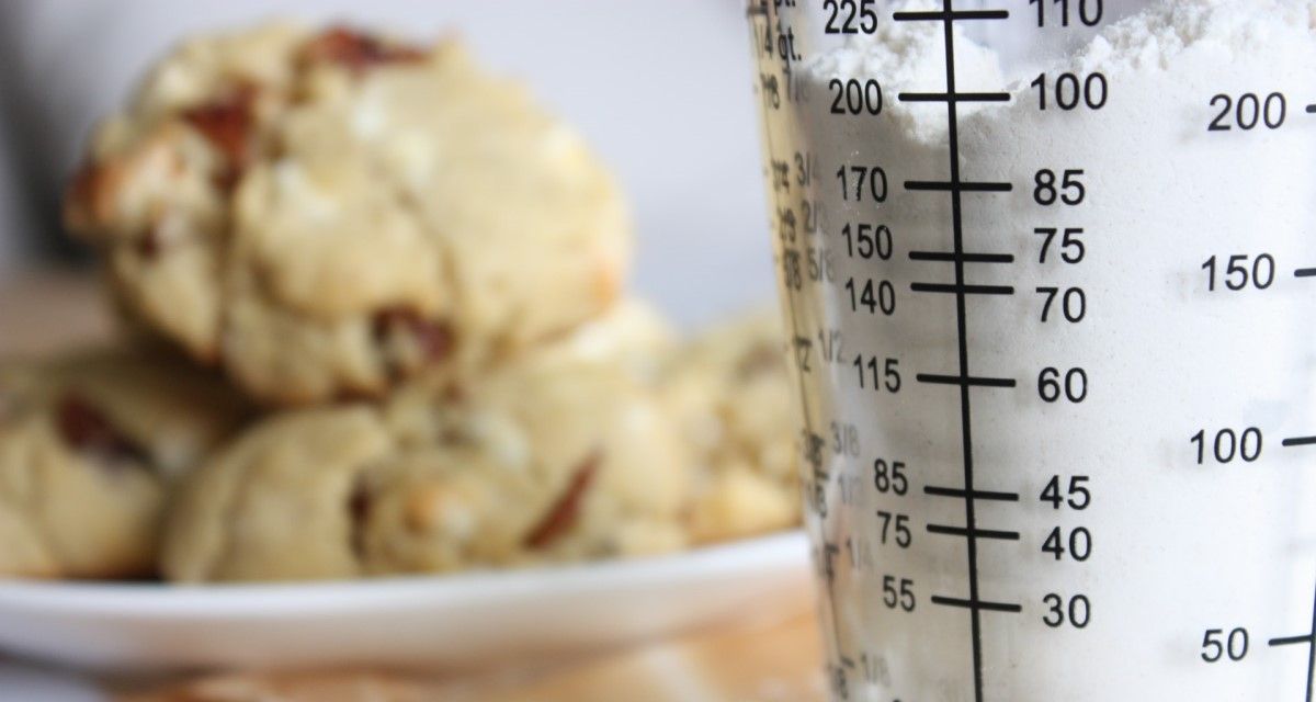 measuring-cup-with-cookies-in-the-background