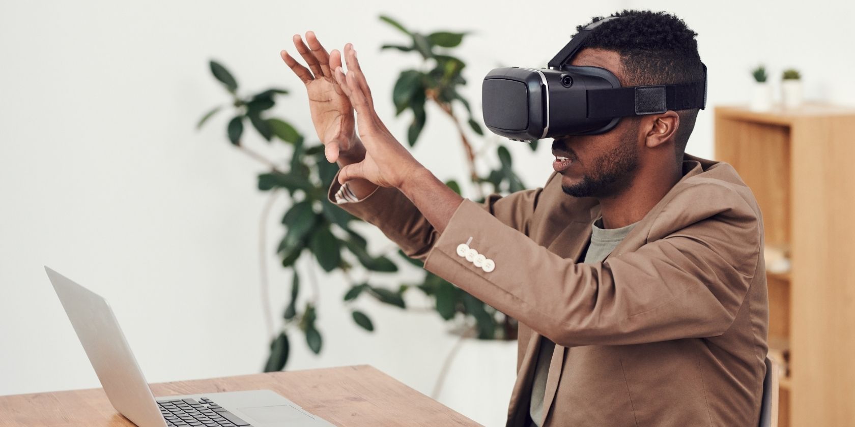 man using virtual reality headset sitting at desk