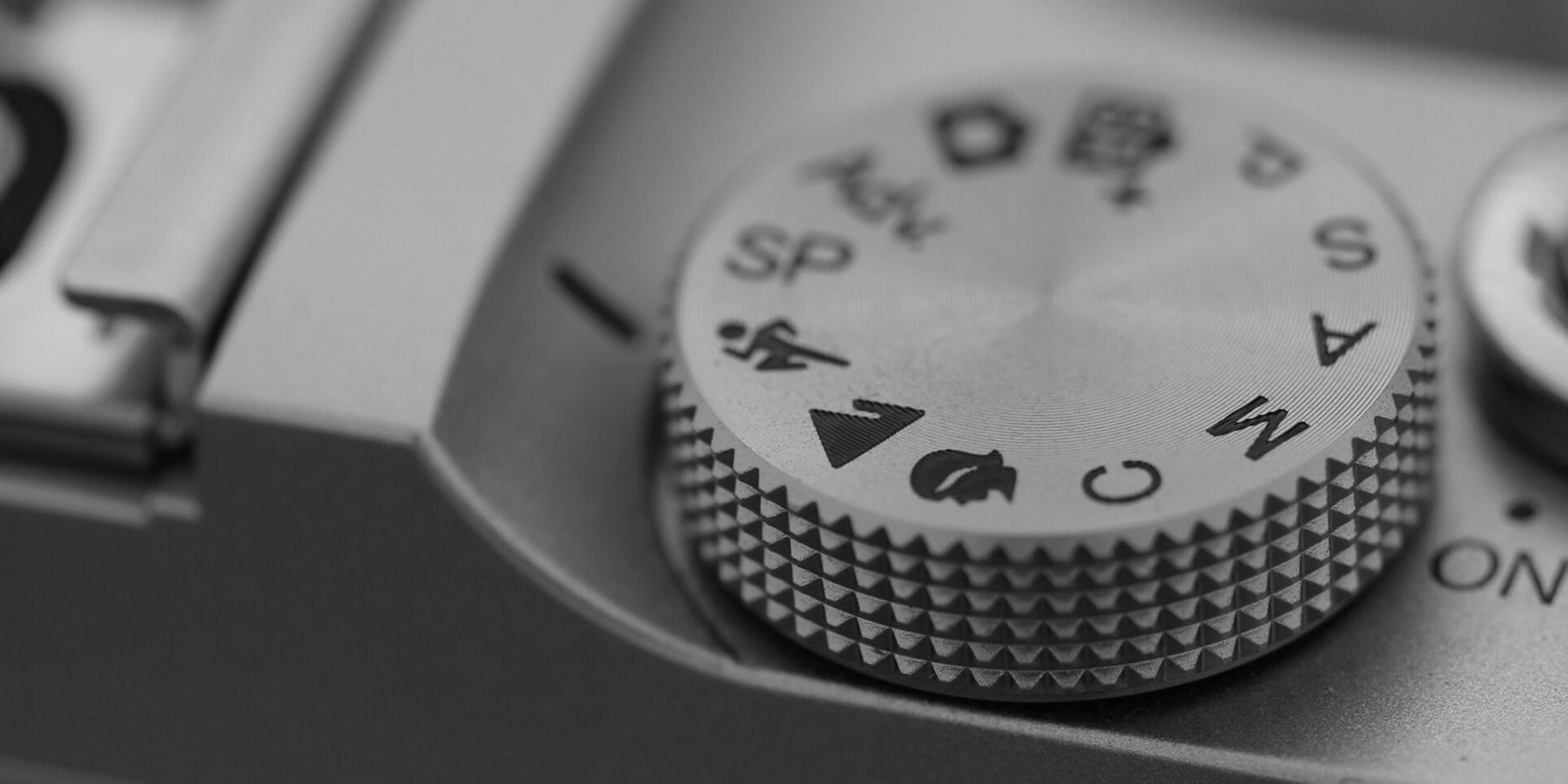 The top dial of an old film camera