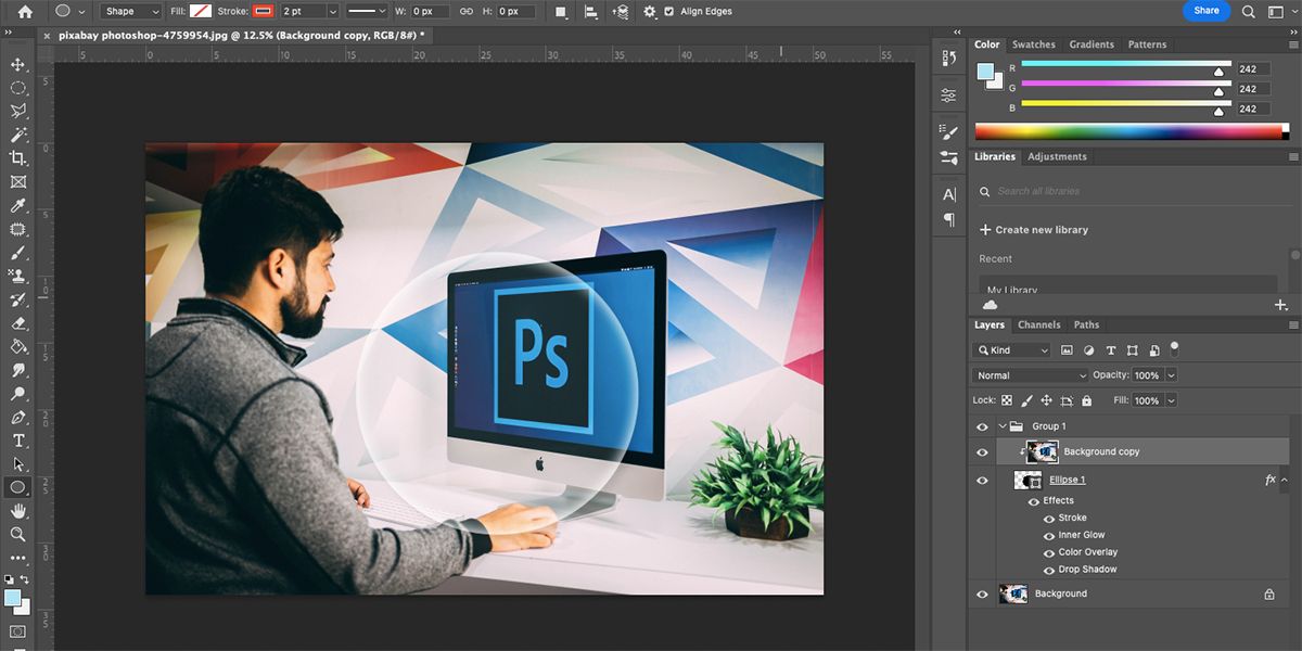 Photoshop with image of man at Mac and a glowing white circular outline on top.