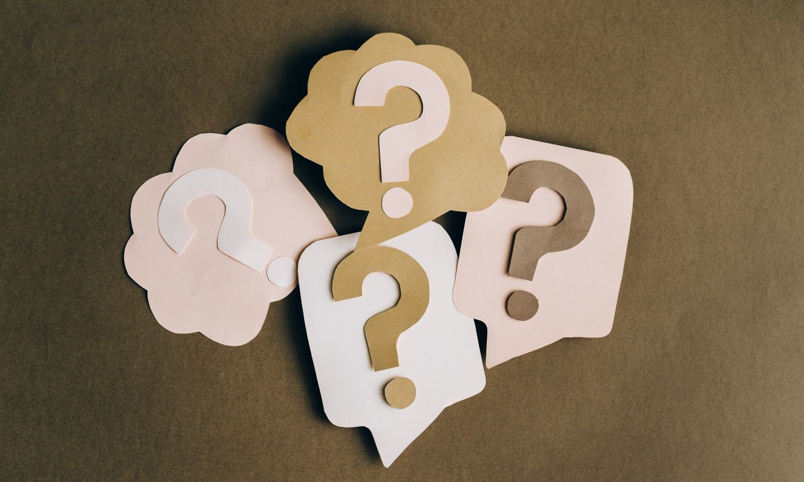 questions trivia cut outs in brown background