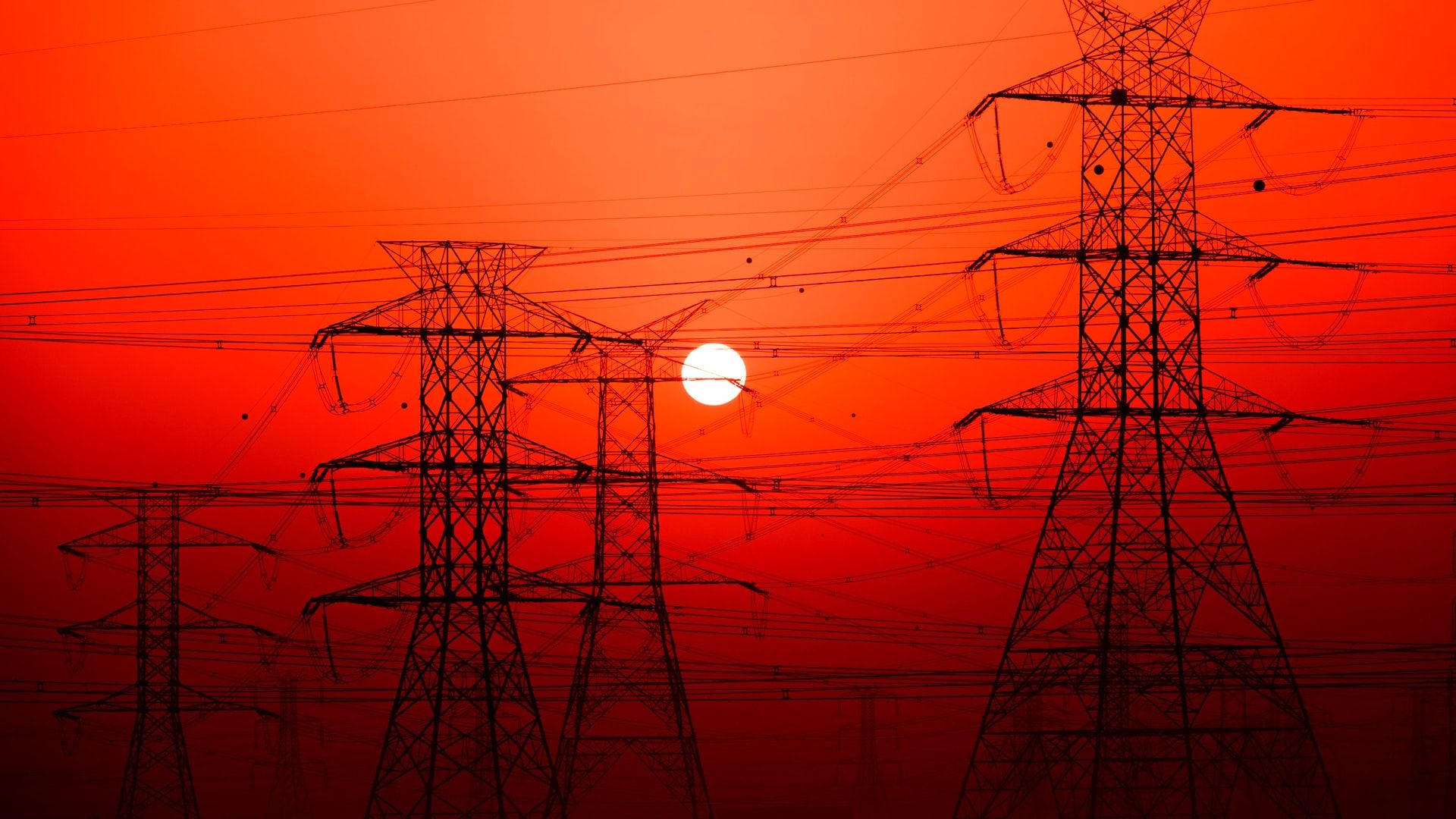 Image of transmission lines and a red sunset