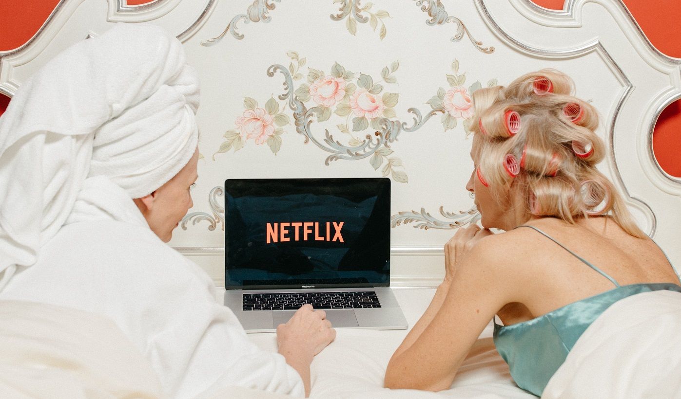 two women with netflix open on laptop