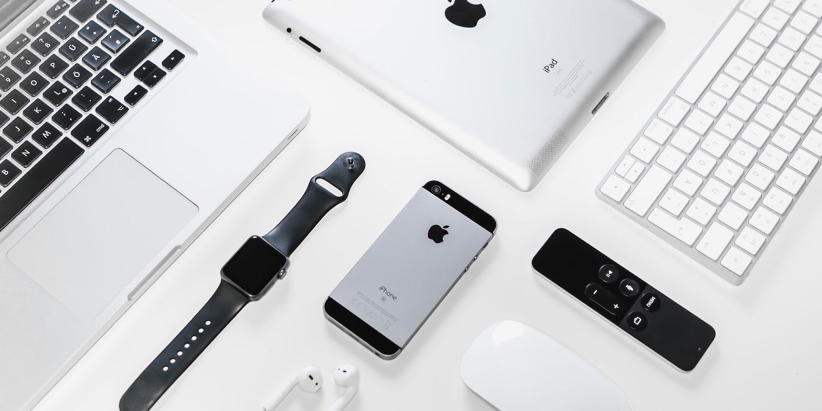 iPhone, Apple Watch, iPad, and Macbook on a table