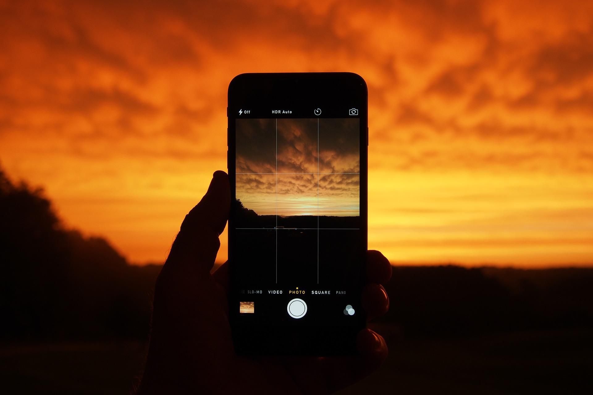 Phone camera with grid showing a sunset scene