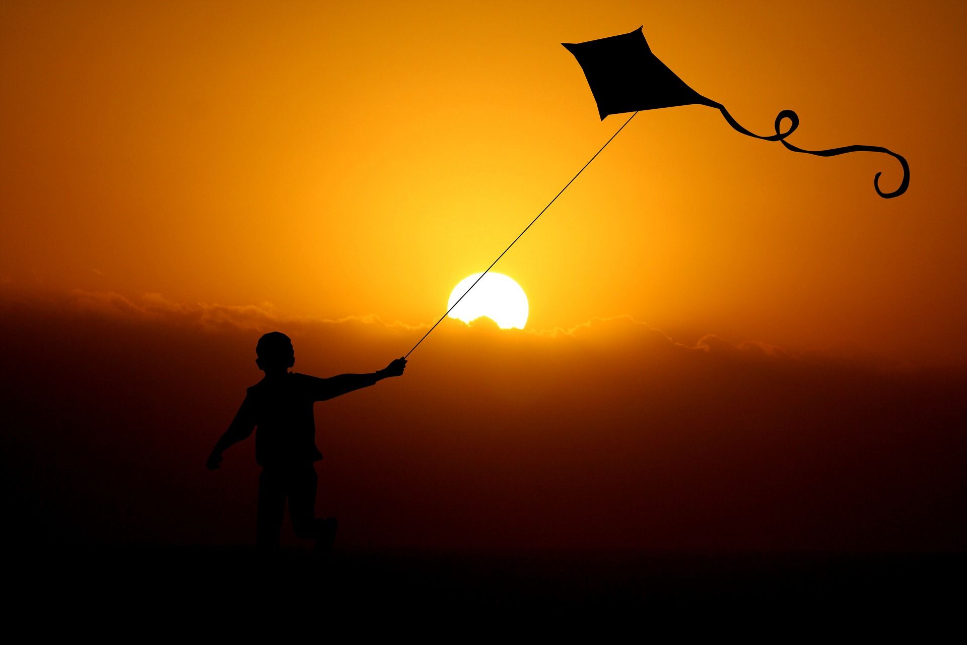 Child with a kite silhouette