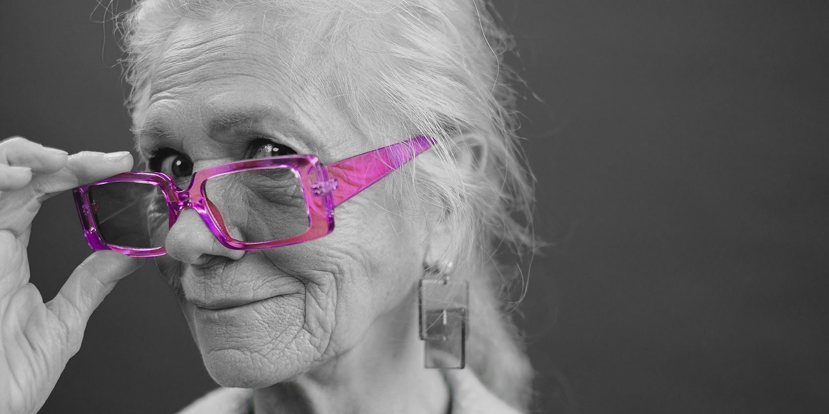 black and white image of lady with pink glasses