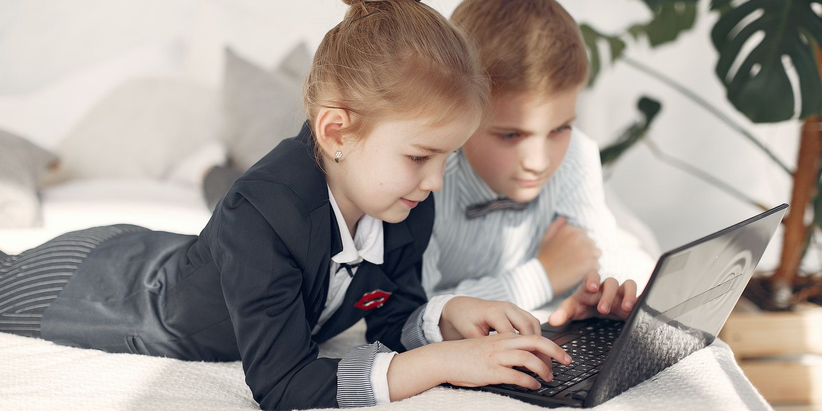 Two Children Browsing the Web on a Laptop