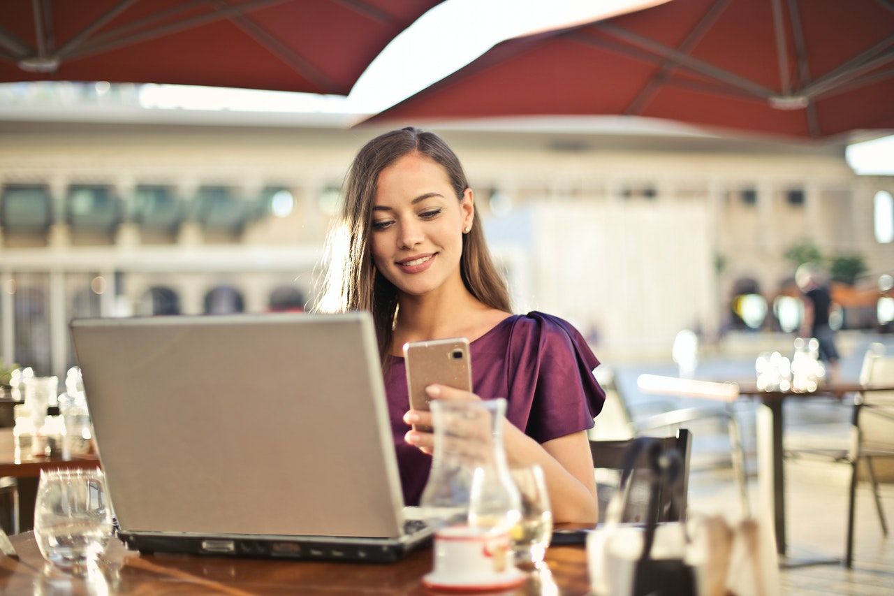 Girl using phone and laptop