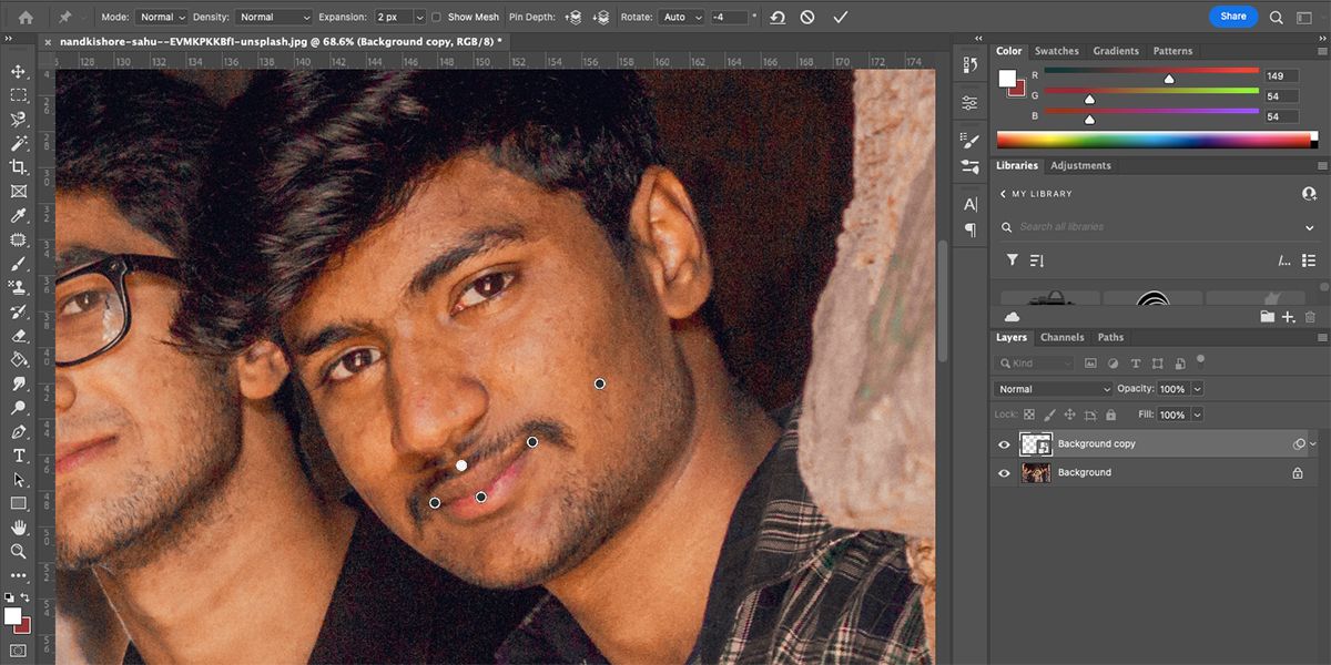 Photoshop interface with man who has multiple pins on face.
