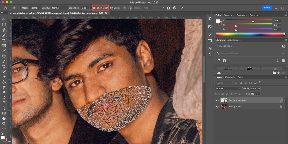 Photoshop interface with image of man and mesh over lower half of face.