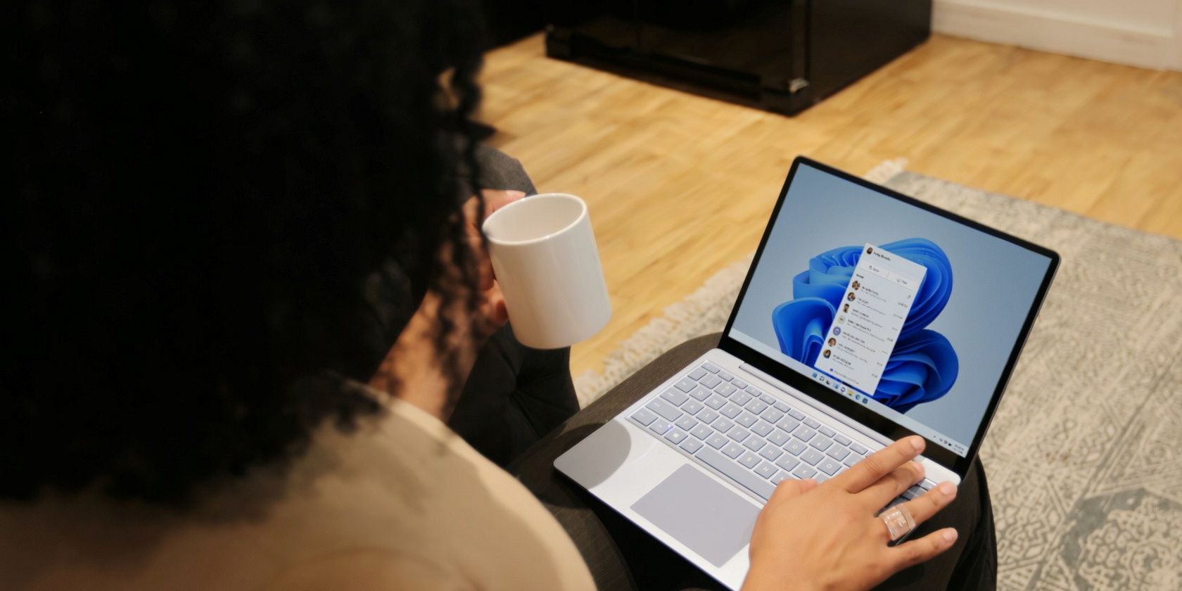 Person Using a Windows PC and holding a cup