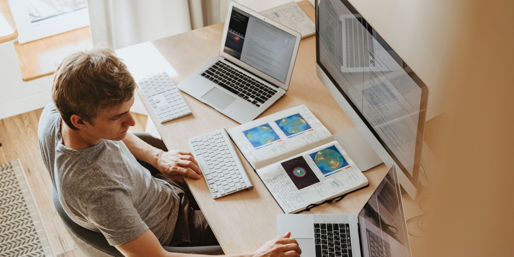 Remote Work image depicting man working on multiple computer systems processing geological data