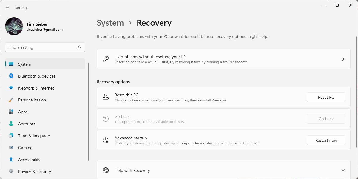 Windows 11 Settings menu with System > Recovery window open.