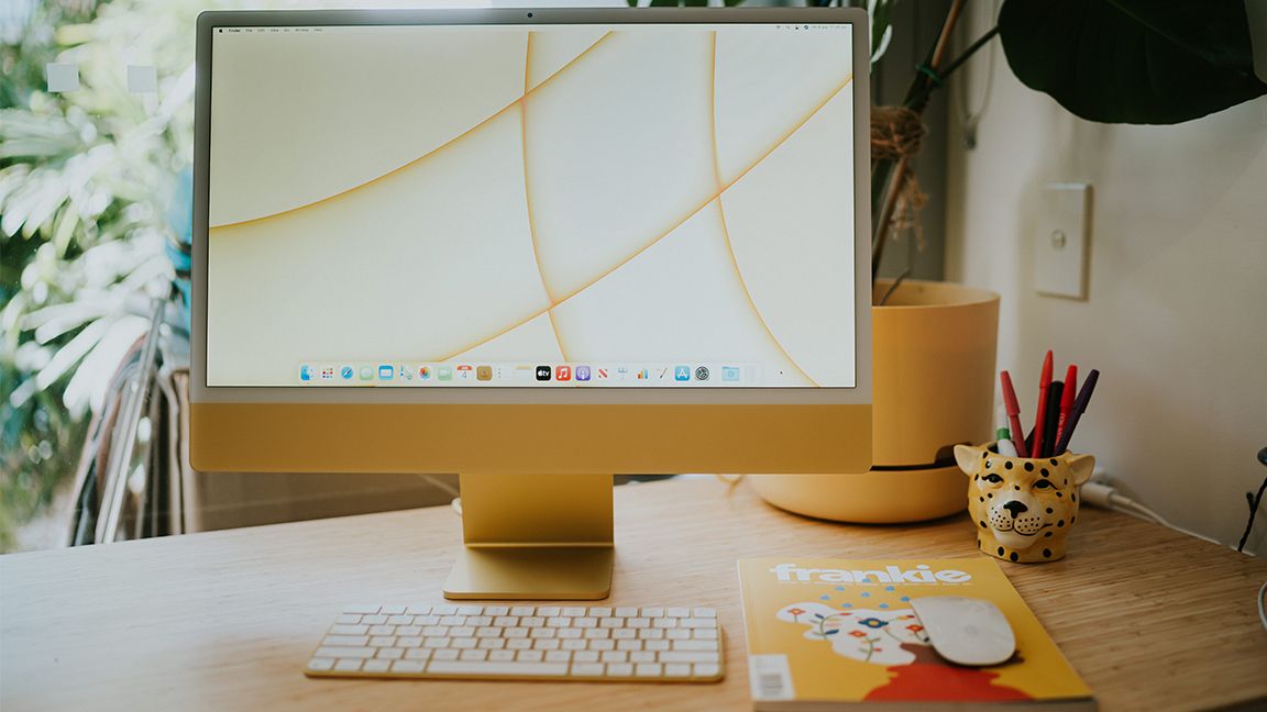 Yellow iMac sitting on desk