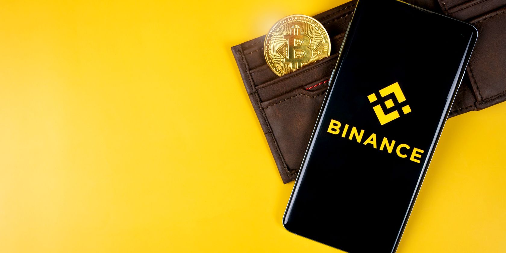 binance logo on smartphone with bitcoin in wallet feature