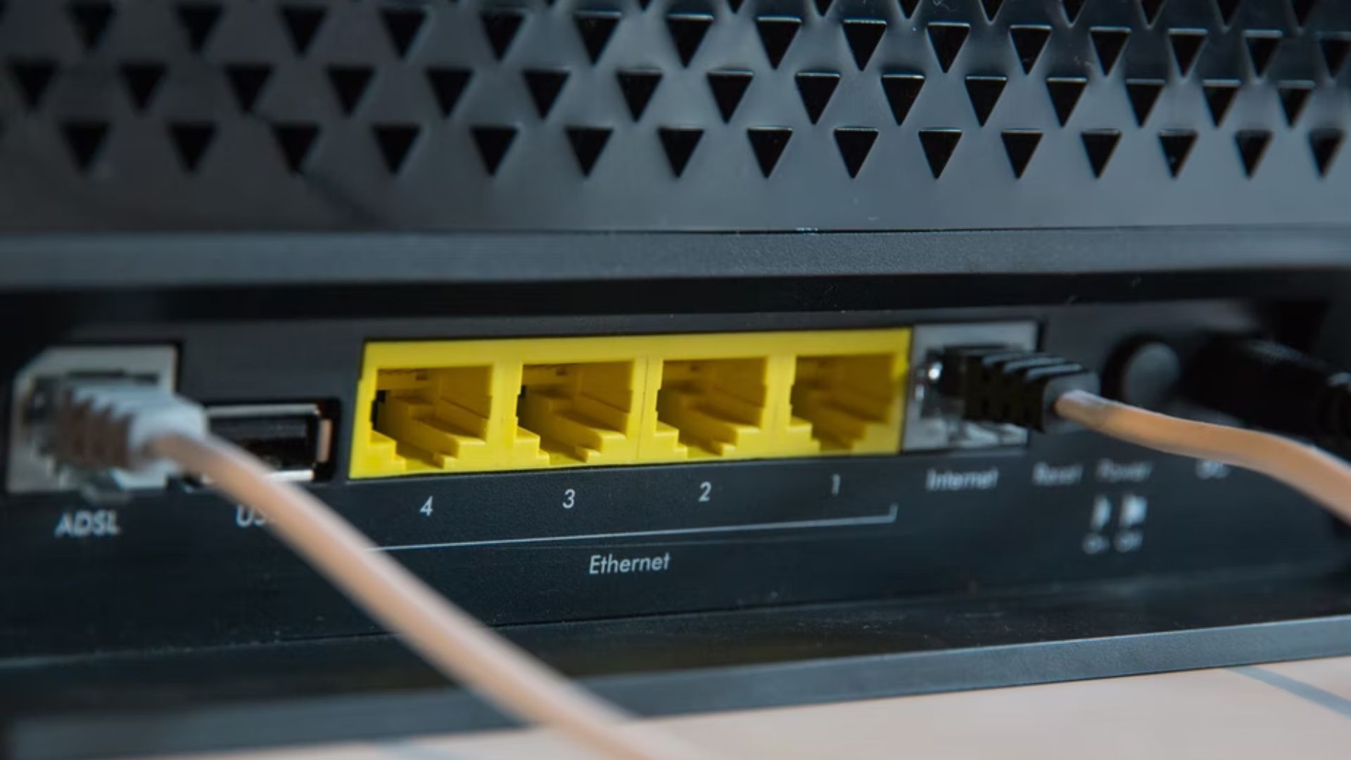 closeup of four open ethernet ports on the back of a router