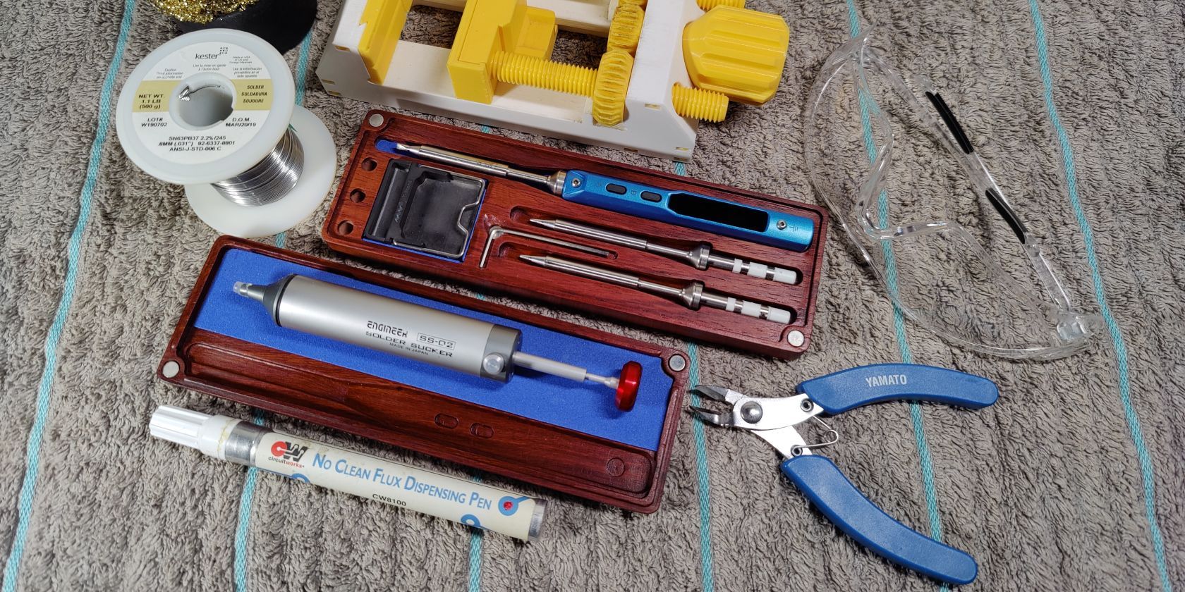 Photo of a desoldering pump and other tools