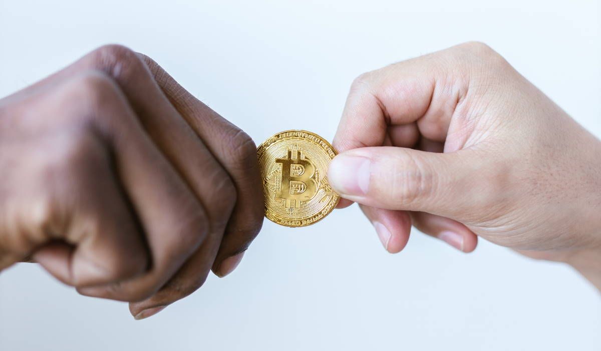 hands-exchanging-bitcoin