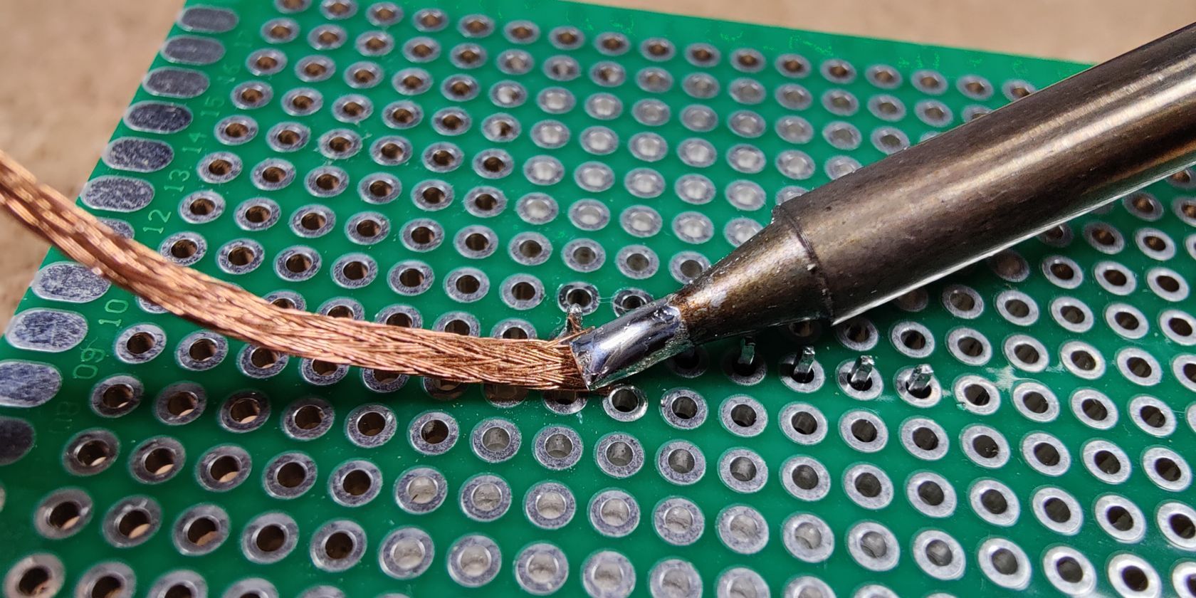 Desoldering PTH joints with a solder wick and soldering iron