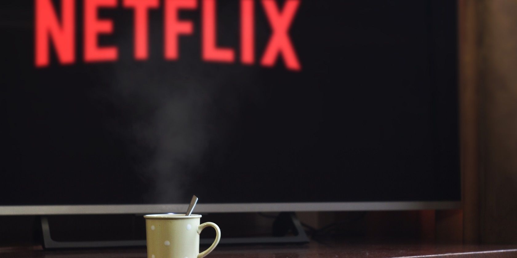 coffee cup infront of tv screen with netflix logo