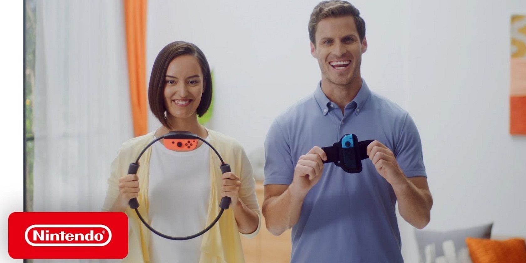 man and woman smiling and holding Nintendo Ring fit adventure device