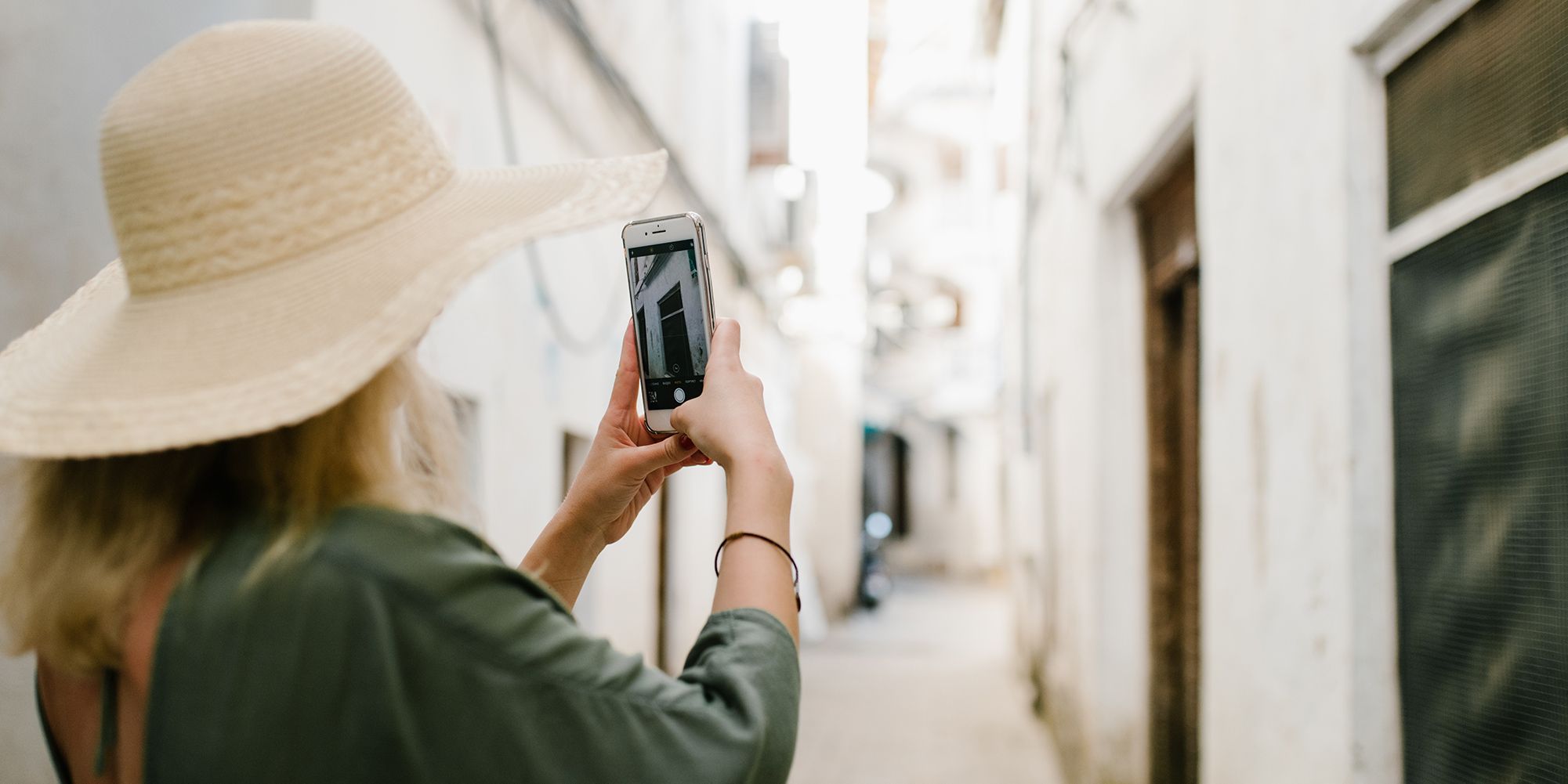 Woman taking picture of a wall with smartphone