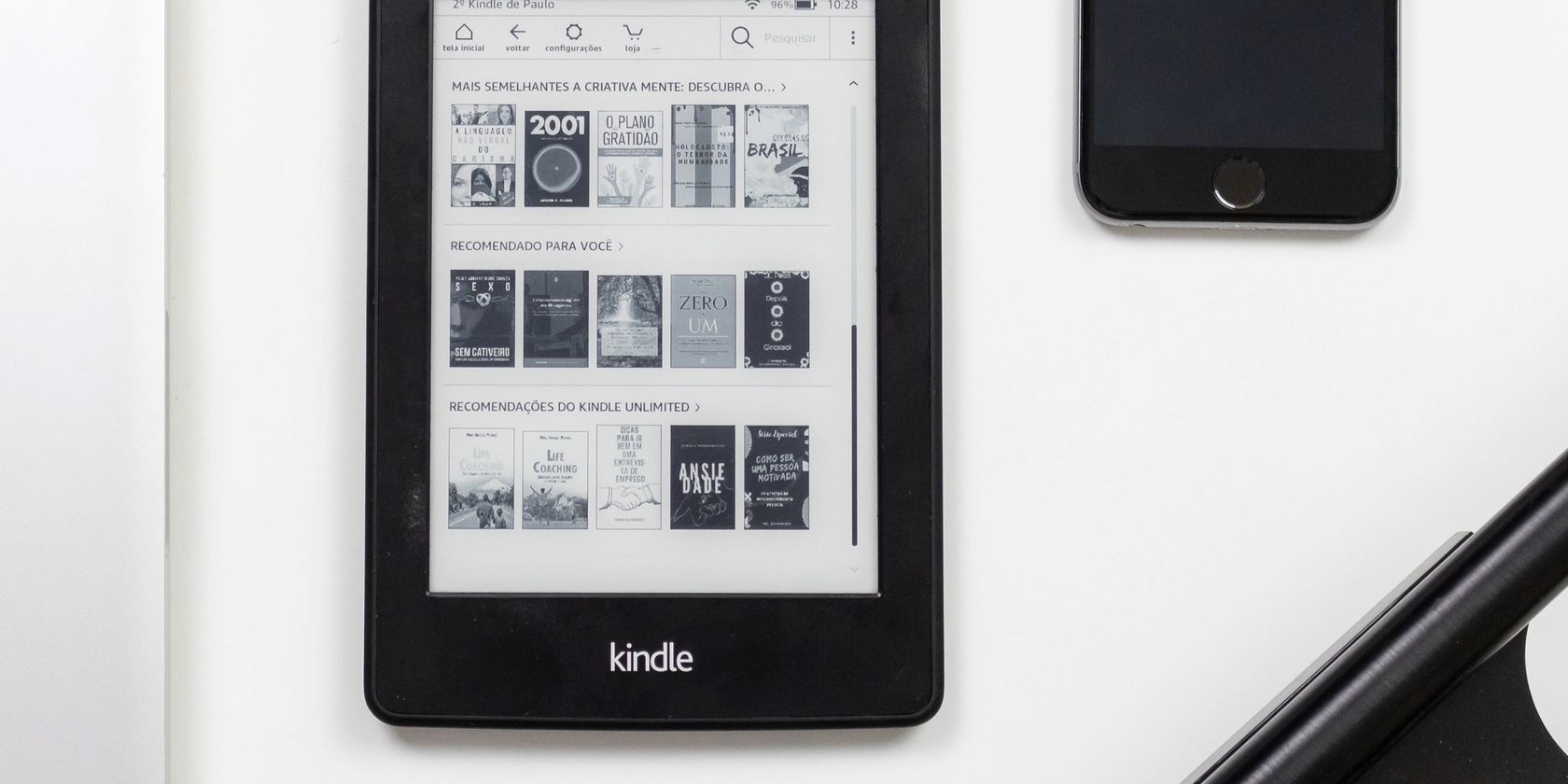 Kindle next to iPhone on white background
