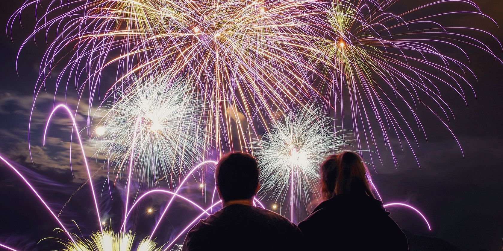 View of a couple watching fireworks.