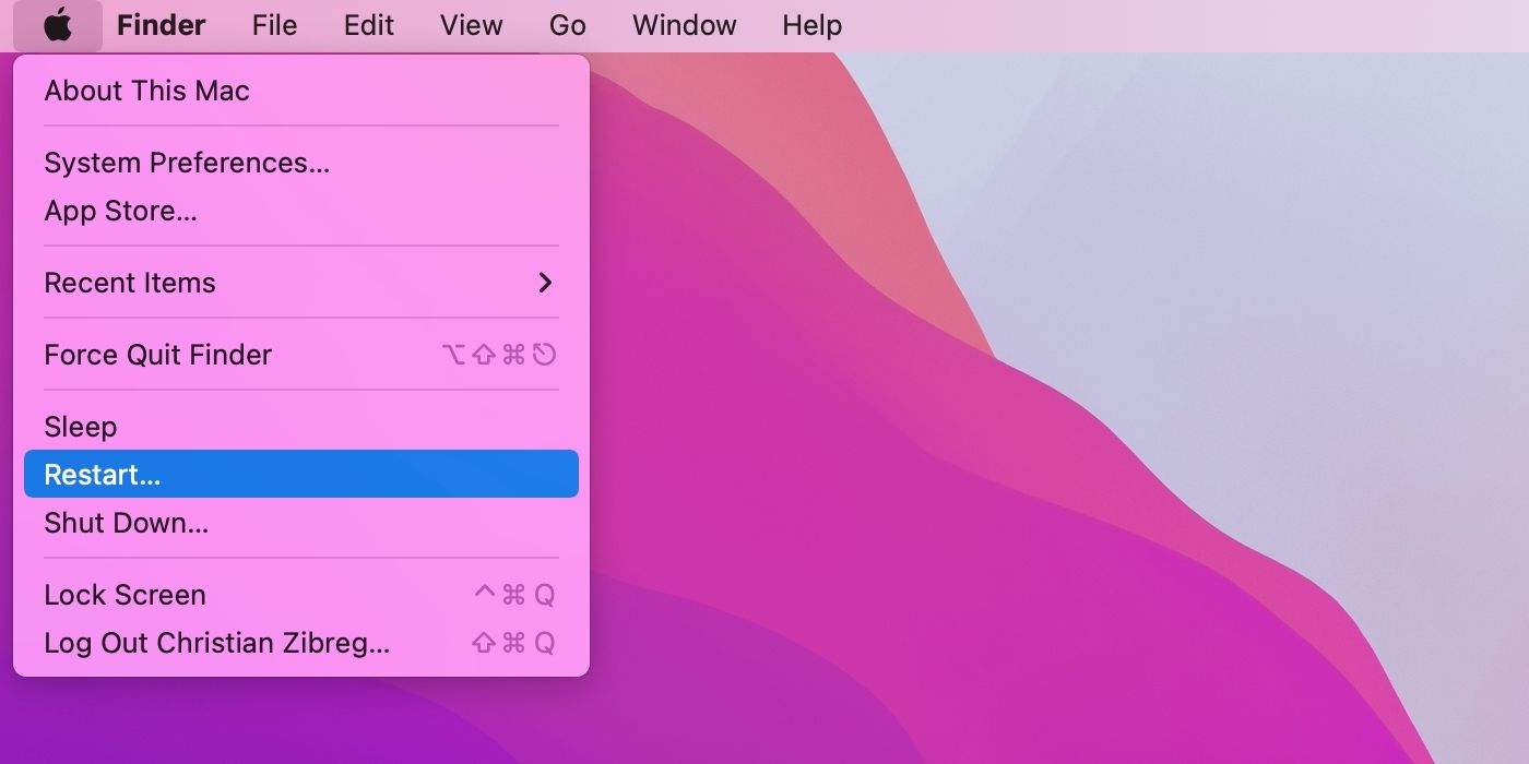 Рабочий стол macOS Monterey по умолчанию с командой «Перезагрузить», выделенной в меню Apple Finder.