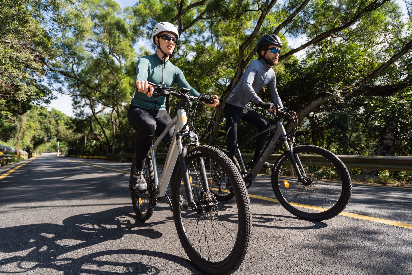 two ado e-bike cyclists riding next to each other
