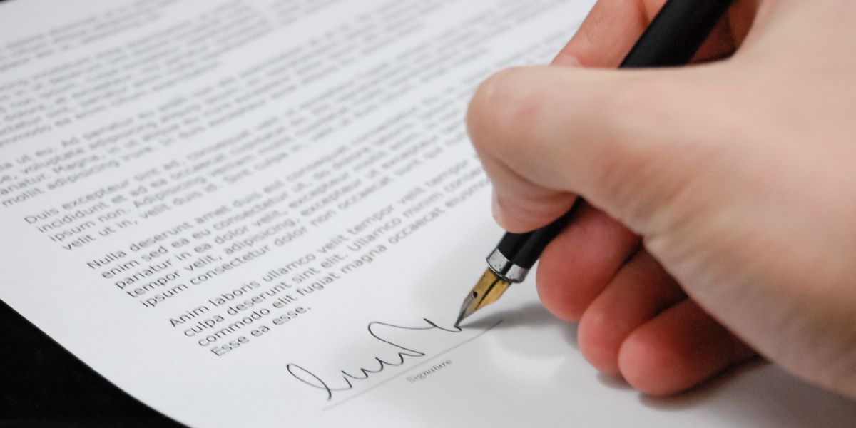 A Hand signing on a document