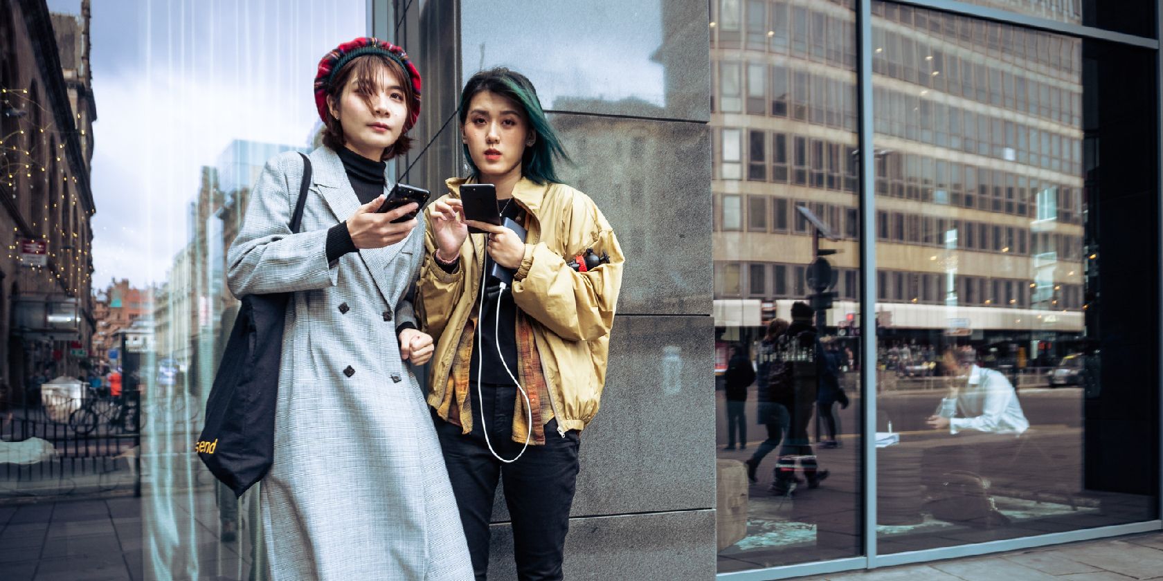 Two women holding phones.