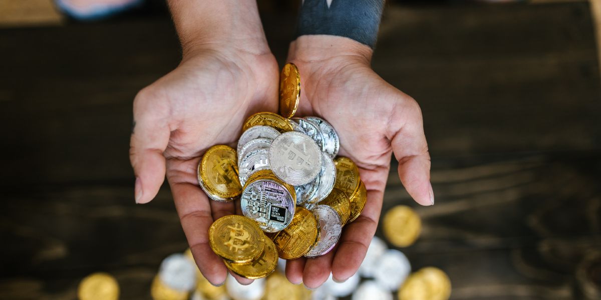 Open hands holding crypto coins