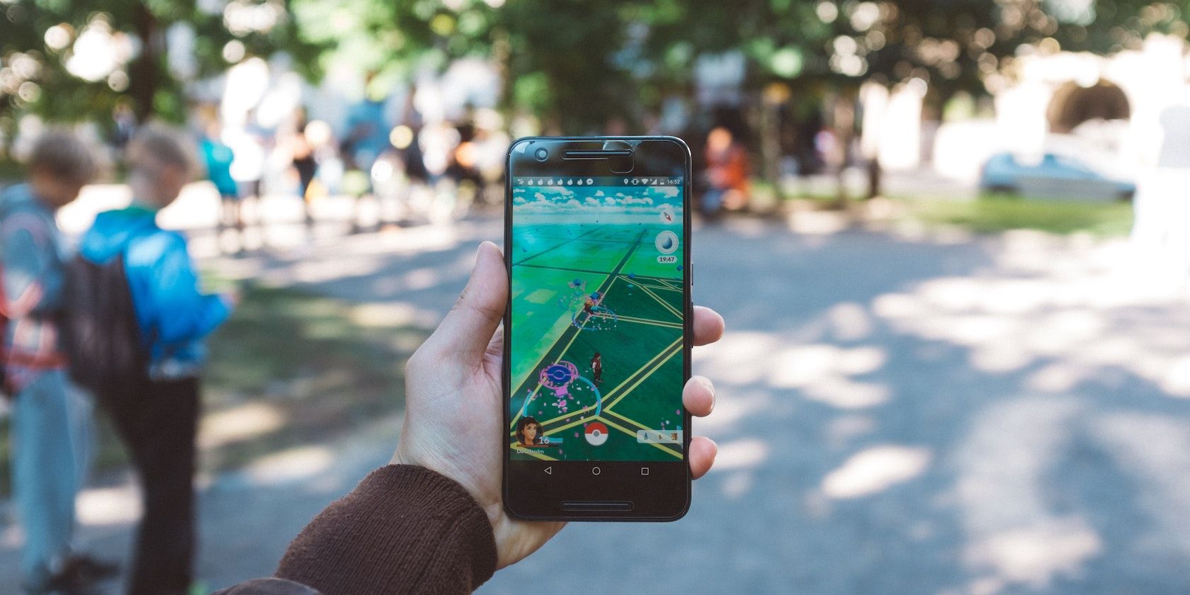 Person holding a smartphone with Pokémon GO Featured Image