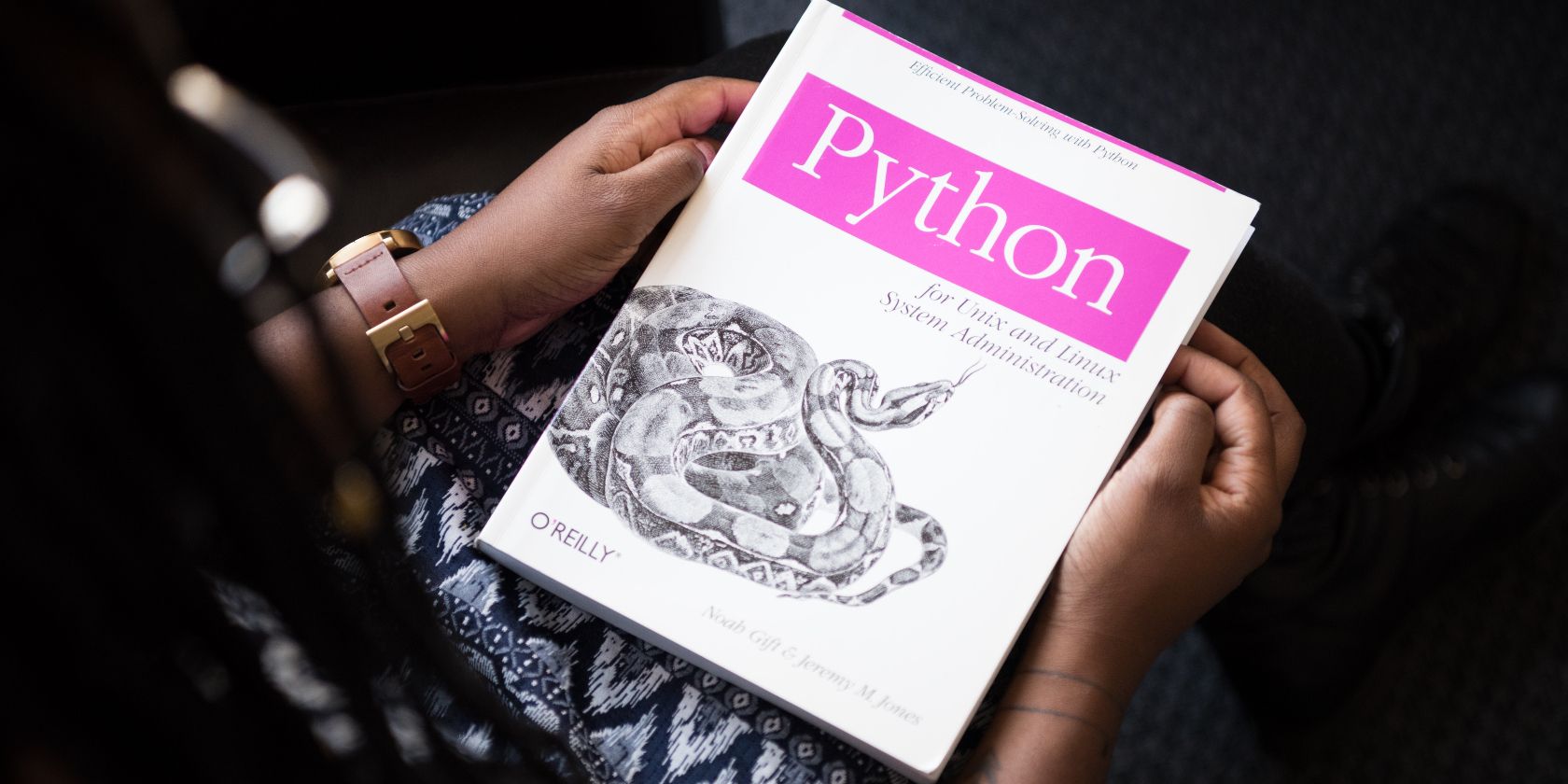 Woman holding a Python book in her hands