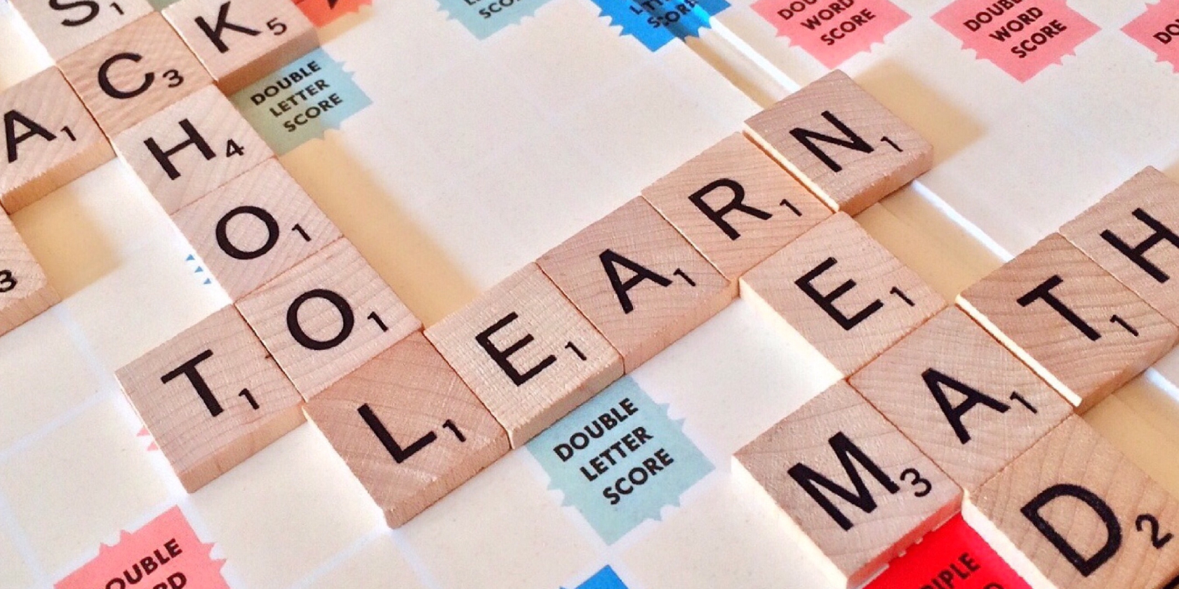 Scrabble board showing the words school, learn and read