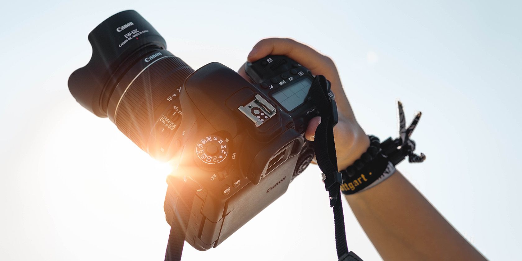 DSLR camera with sun flare in the back 
