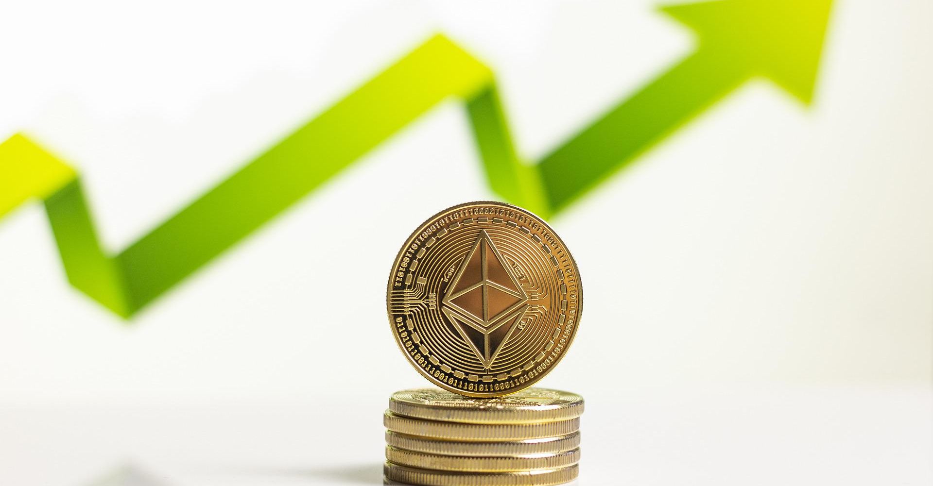 stack of ethereum coins in front of green upward arrow